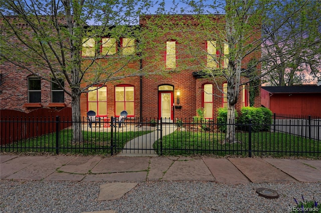 1717 E 22nd Ave, Denver, CO 80205 - view of front facade with a fenced front yard, a front lawn, and brick siding