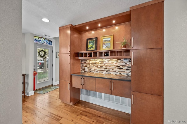 1717 E 22nd Ave, Denver, CO 80205 - interior space with a textured ceiling, light wood-style floors, baseboards, and tasteful backsplash