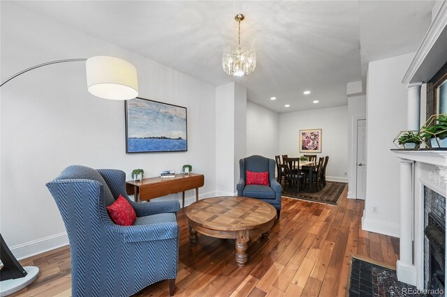 1717 E 22nd Ave, Denver, CO 80205 - sitting room with a fireplace, baseboards, wood-type flooring, a notable chandelier, and recessed lighting