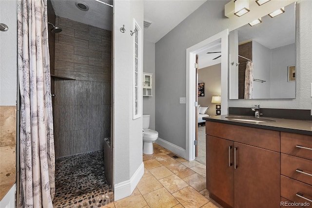 1717 E 22nd Ave, Denver, CO 80205 - full bath featuring vanity, tile patterned flooring, a tile shower, and toilet