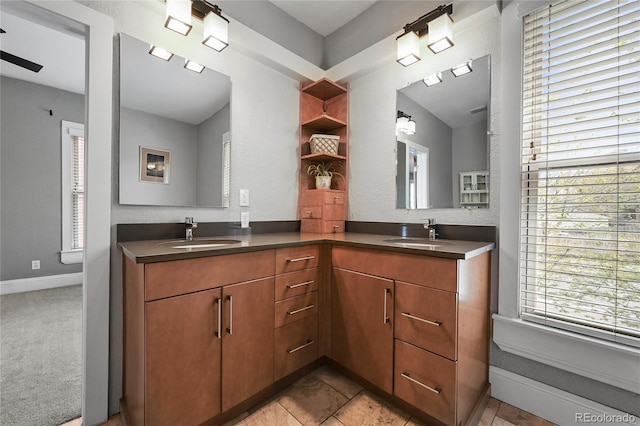 1717 E 22nd Ave, Denver, CO 80205 - bathroom featuring double vanity, a sink, and baseboards