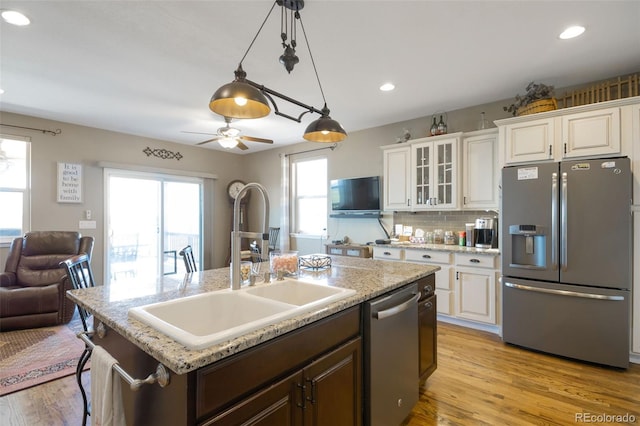 3560 Zane Gray Loop, Parker, CO 80138 - kitchen featuring appliances with stainless steel finishes, an island with sink, healthy amount of natural light, white cabinetry, and recessed lighting