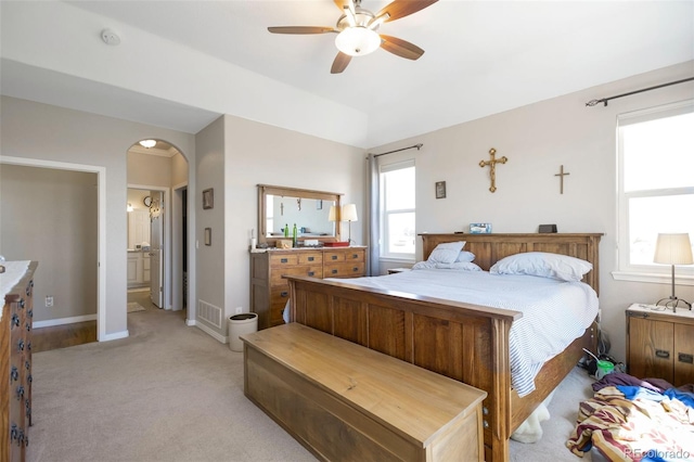 3560 Zane Gray Loop, Parker, CO 80138 - bedroom with light colored carpet, arched walkways, and a ceiling fan