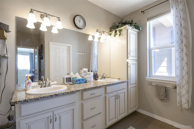 3560 Zane Gray Loop, Parker, CO 80138 - bathroom featuring double vanity, tile patterned floors, and plenty of natural light