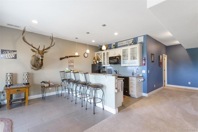 3560 Zane Gray Loop, Parker, CO 80138 - kitchen with a kitchen breakfast bar, white cabinets, tasteful backsplash, black appliances, and recessed lighting