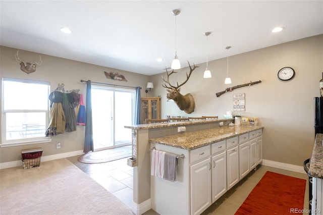 3560 Zane Gray Loop, Parker, CO 80138 - kitchen featuring a peninsula, white cabinetry, light stone countertops, decorative light fixtures, and recessed lighting