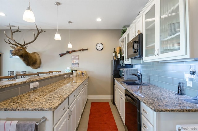 3560 Zane Gray Loop, Parker, CO 80138 - kitchen featuring white cabinetry, decorative backsplash, black appliances, stone countertops, and glass insert cabinets