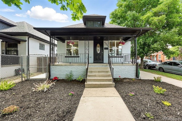 4059 Quivas St, Denver, CO 80211 - view of front facade with covered porch, a gate, and a shingled roof