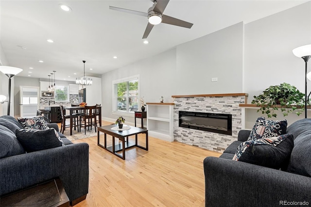 4059 Quivas St, Denver, CO 80211 - living room featuring light wood-style flooring, a fireplace, recessed lighting, a ceiling fan, and a chandelier