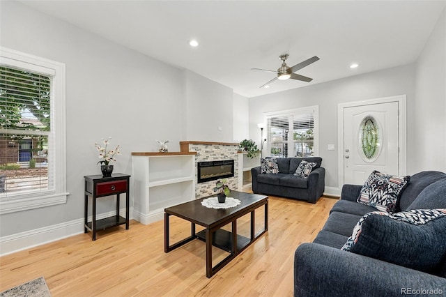 4059 Quivas St, Denver, CO 80211 - living area featuring a ceiling fan, light wood-style flooring, a tiled fireplace, and recessed lighting