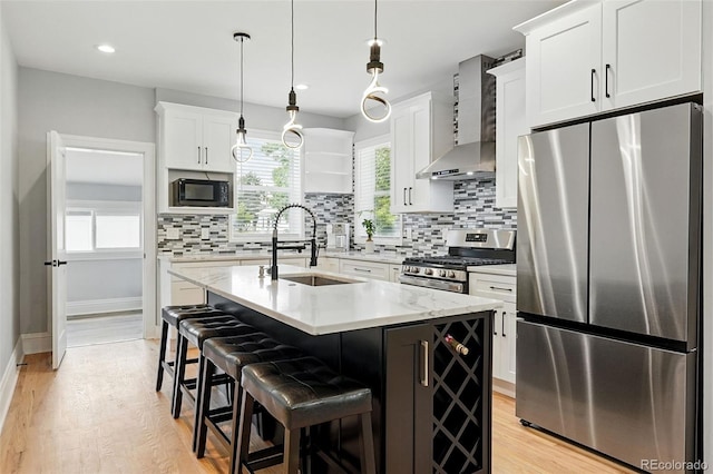 4059 Quivas St, Denver, CO 80211 - kitchen with appliances with stainless steel finishes, wall chimney exhaust hood, backsplash, white cabinetry, and recessed lighting