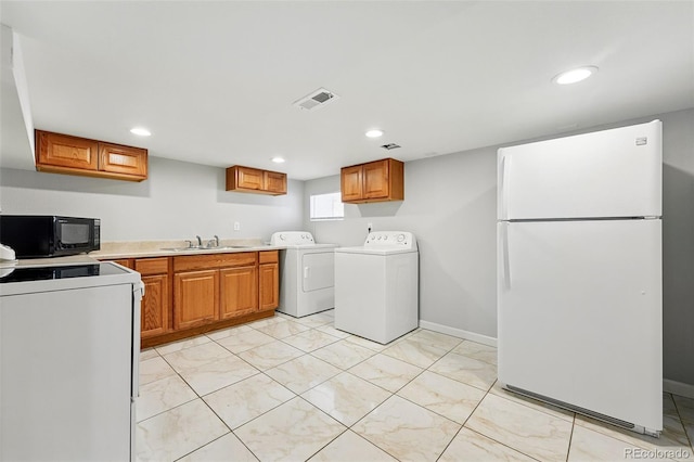 4059 Quivas St, Denver, CO 80211 - washroom featuring washing machine and clothes dryer, recessed lighting, and light marble finish floors