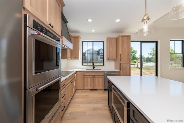 kitchen featuring light brown cabinets, a sink, plenty of natural light, appliances with stainless steel finishes, and recessed lighting