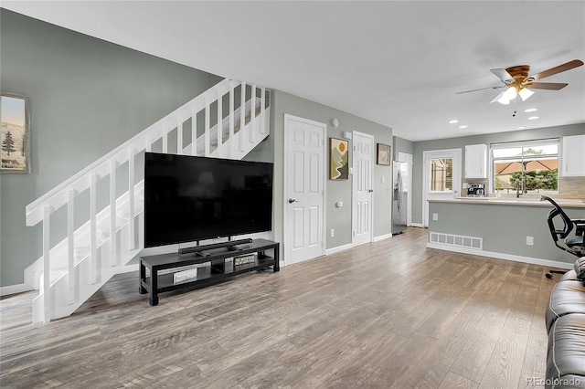 9615 W Chatfield Ave Unit C, Littleton, CO 80128 - living room with stairway, wood finished floors, ceiling fan, and recessed lighting