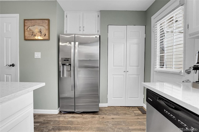 9615 W Chatfield Ave Unit C, Littleton, CO 80128 - kitchen with stainless steel appliances, dark wood-style floors, white cabinets, and light stone countertops