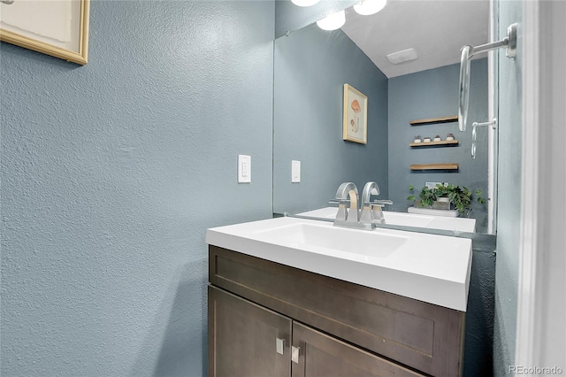 9615 W Chatfield Ave Unit C, Littleton, CO 80128 - bathroom with vanity and a textured wall