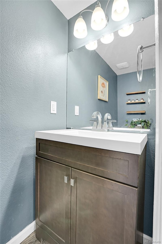 9615 W Chatfield Ave Unit C, Littleton, CO 80128 - bathroom with vanity, a textured wall, and wood finished floors