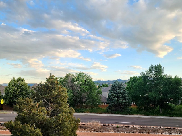 9615 W Chatfield Ave Unit C, Littleton, CO 80128 - view of asphalt road featuring traffic signs and a mountain view