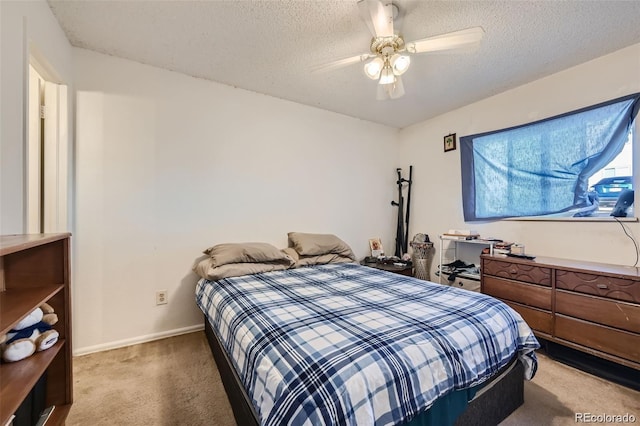 2241 Dexter Dr Unit 3, Longmont, CO 80501 - bedroom with light colored carpet, a textured ceiling, and ceiling fan