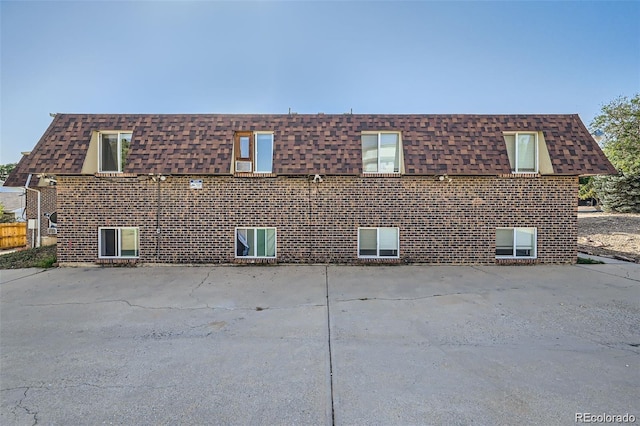 2241 Dexter Dr Unit 3, Longmont, CO 80501 - view of side of property with a shingled roof, mansard roof, and brick siding