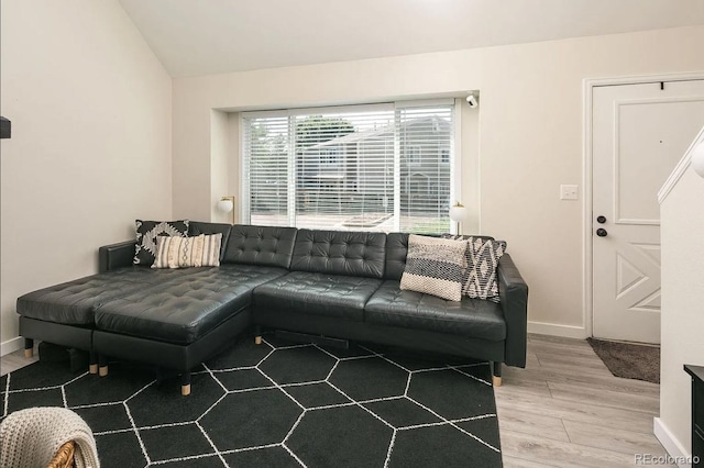 living room with light wood-type flooring and lofted ceiling