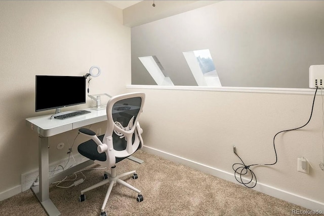 office space featuring carpet floors and a skylight