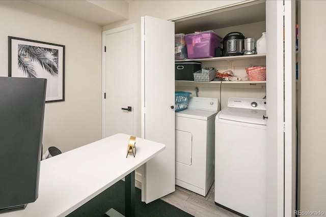 laundry area with light wood-type flooring and independent washer and dryer