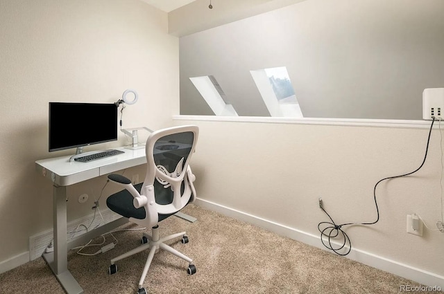 carpeted home office featuring a skylight