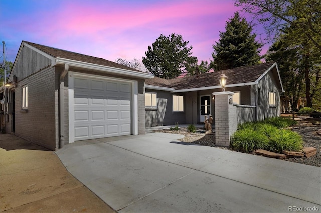 4500 Zephyr St, Wheat Ridge, CO 80033 - ranch-style house featuring brick siding, an attached garage, and concrete driveway