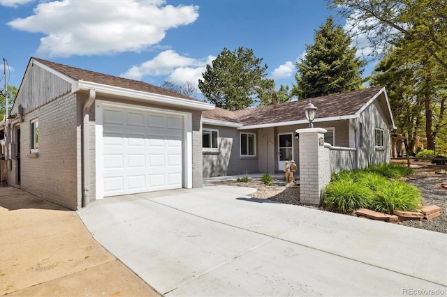 4500 Zephyr St, Wheat Ridge, CO 80033 - ranch-style home with brick siding, a garage, and driveway