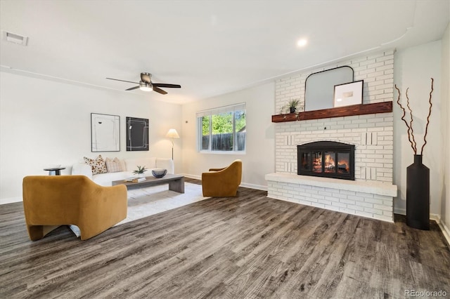 4500 Zephyr St, Wheat Ridge, CO 80033 - living room featuring wood finished floors, a ceiling fan, a brick fireplace, and baseboards
