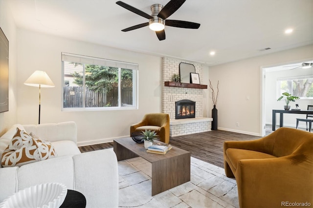 4500 Zephyr St, Wheat Ridge, CO 80033 - living room featuring ceiling fan, healthy amount of natural light, light wood-style flooring, a fireplace, and recessed lighting