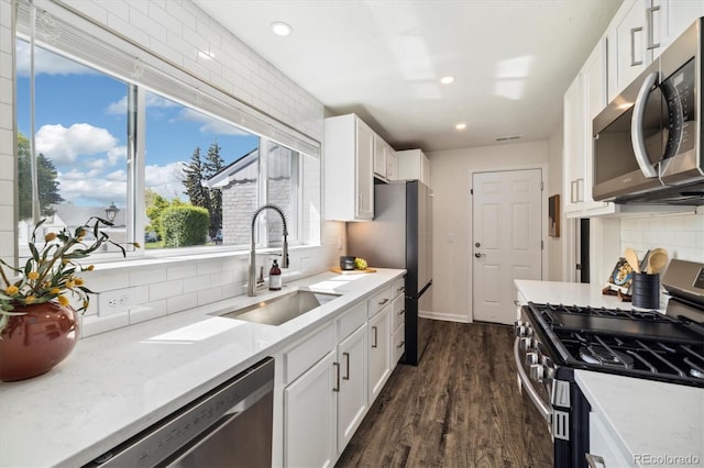 4500 Zephyr St, Wheat Ridge, CO 80033 - kitchen with stainless steel appliances, a sink, tasteful backsplash, white cabinets, and recessed lighting