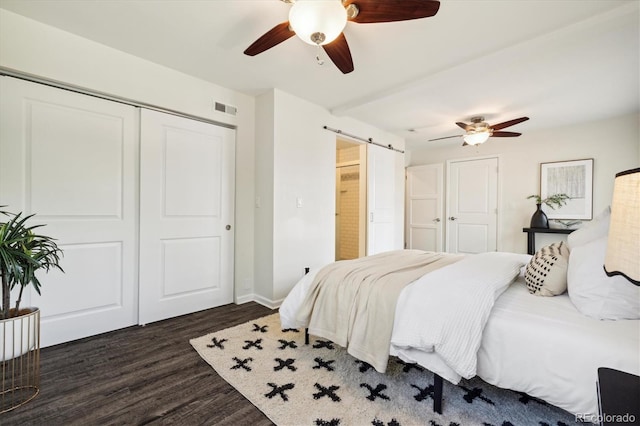 4500 Zephyr St, Wheat Ridge, CO 80033 - bedroom with a barn door, wood finished floors, a closet, a ceiling fan, and baseboards
