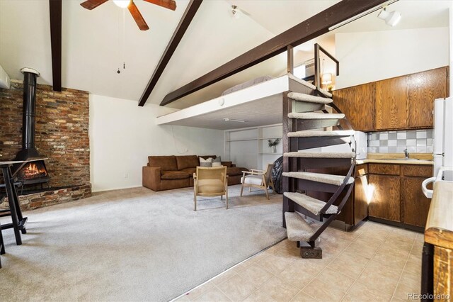 4500 Zephyr St, Wheat Ridge, CO 80033 - living area with a ceiling fan, light carpet, a wood stove, light tile patterned floors, and stairway