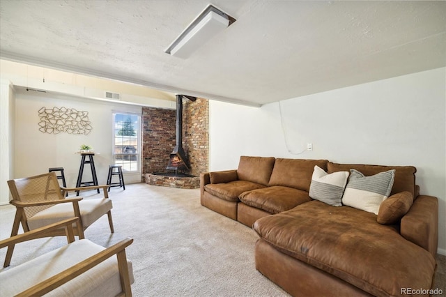 4500 Zephyr St, Wheat Ridge, CO 80033 - living room featuring a wood stove and light colored carpet