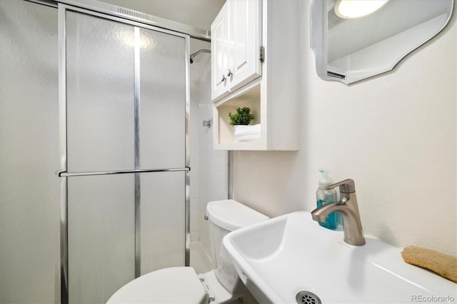 4500 Zephyr St, Wheat Ridge, CO 80033 - bathroom featuring a sink, a shower stall, and toilet