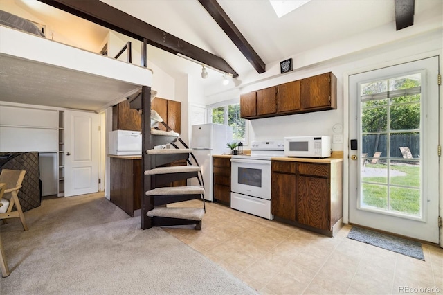 4500 Zephyr St, Wheat Ridge, CO 80033 - kitchen with white appliances, beamed ceiling, light countertops, light tile patterned floors, and dark brown cabinets
