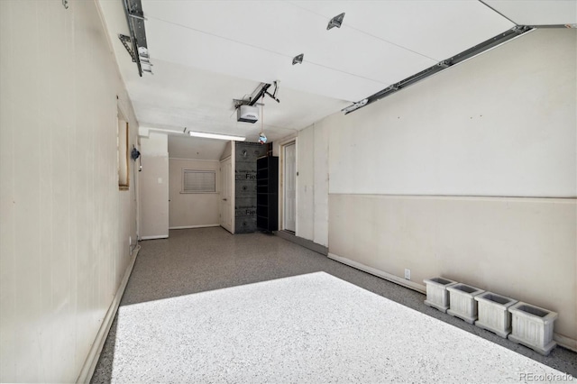 4500 Zephyr St, Wheat Ridge, CO 80033 - garage with baseboards and a garage door opener