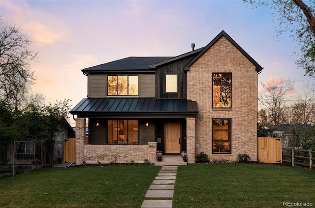 1680 S Humboldt St, Denver, CO 80210 - view of front of home with a standing seam roof, brick siding, metal roof, and covered porch