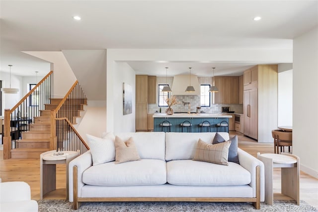 1680 S Humboldt St, Denver, CO 80210 - living room with light wood finished floors, recessed lighting, and stairway