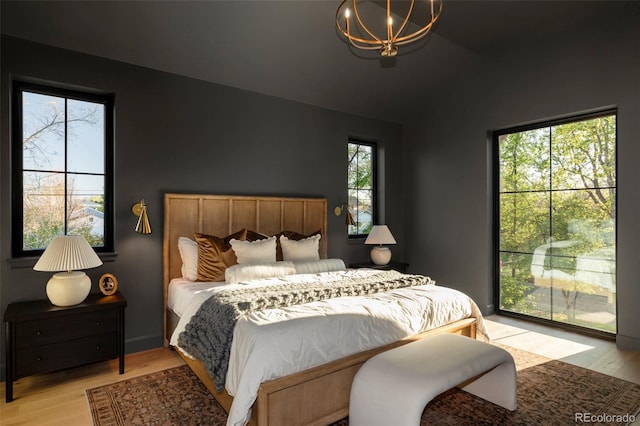 1680 S Humboldt St, Denver, CO 80210 - bedroom with a chandelier, light wood-type flooring, and lofted ceiling