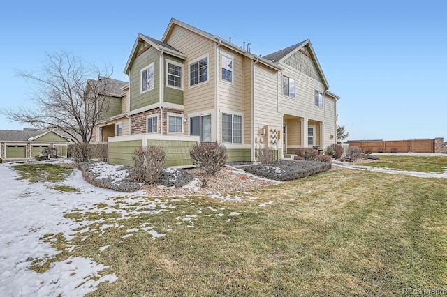 snow covered property with a lawn