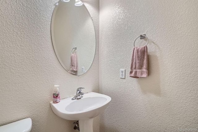 bathroom with toilet and sink