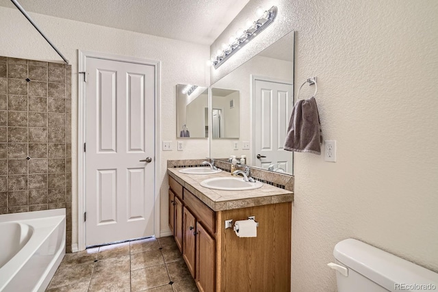 full bathroom with tile patterned flooring, a textured ceiling, toilet, vanity, and bathtub / shower combination