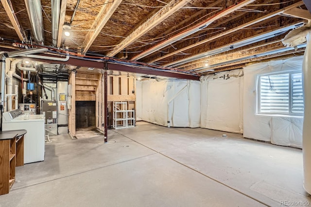 basement featuring water heater and independent washer and dryer