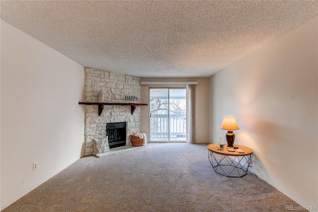 unfurnished living room with carpet floors, a textured ceiling, and a fireplace