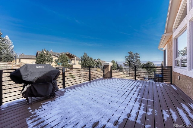 wooden deck featuring a grill