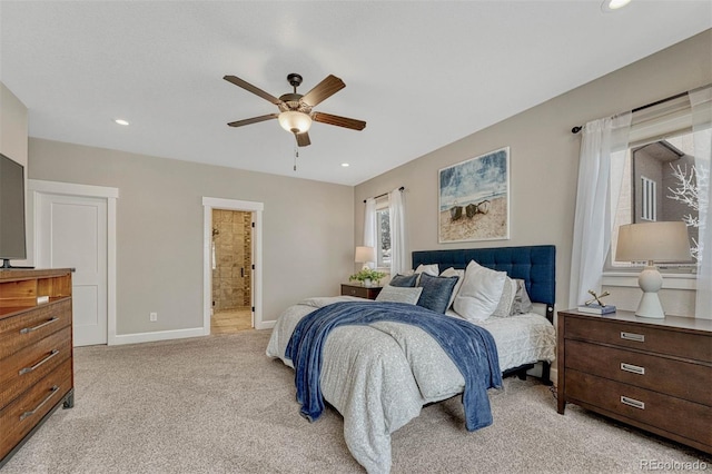 bedroom featuring light carpet, ensuite bath, baseboards, and recessed lighting