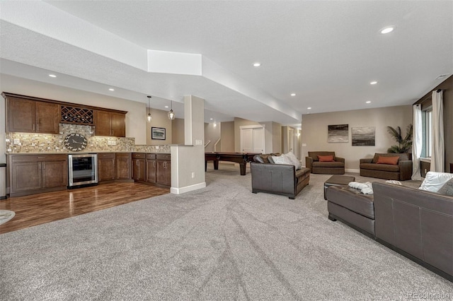 living area featuring wet bar, beverage cooler, carpet flooring, and recessed lighting